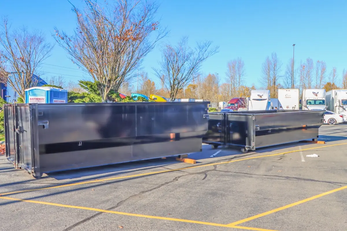 Professional dumpster rental service with roll-off container on residential driveway in New London